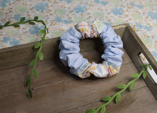 handmade hair scrunchie using the trans flag colours in small sections, angle 2